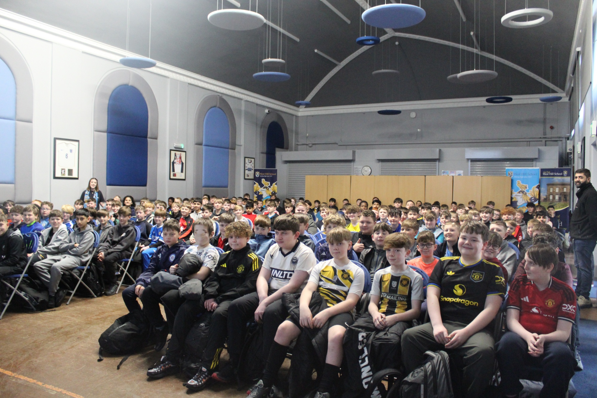 Boys wearing football shirts in memory of Haaris