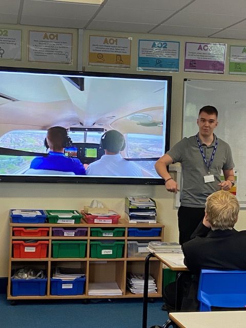 A photo of an ex-student turned Pilot talking to current students