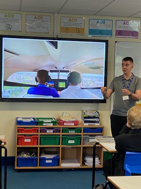 A photo of an ex-student turned Pilot talking to current students